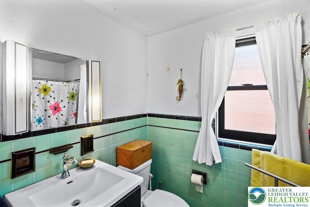 1321 W Union Blvd, Bethlehem City, PA 18018 - full bathroom with tile walls, a wainscoted wall, and vanity