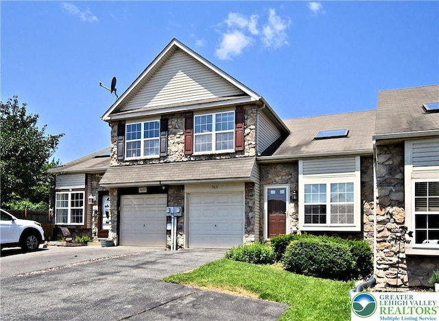 5631 Stonecroft Ln, Lower Macungie Twp, PA 18106 - view of front of house with stone siding, a garage, and driveway