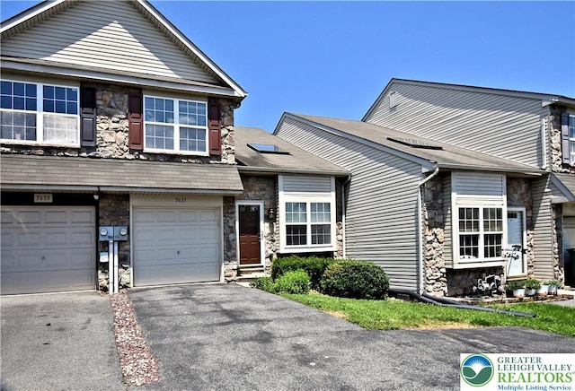 5631 Stonecroft Ln, Lower Macungie Twp, PA 18106 - view of front of home featuring stone siding, driveway, and an attached garage