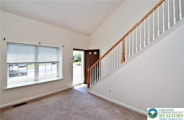 5631 Stonecroft Ln, Lower Macungie Twp, PA 18106 - entryway with carpet flooring, stairs, and high vaulted ceiling