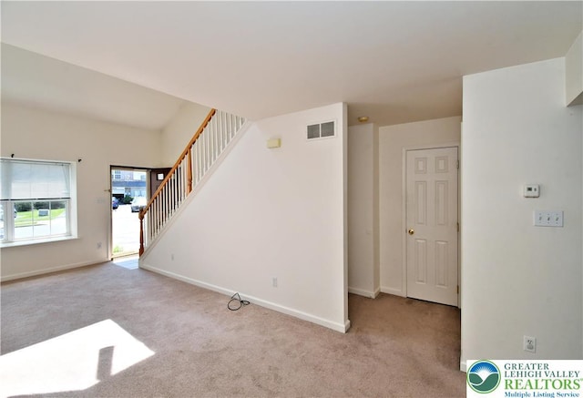 5631 Stonecroft Ln, Lower Macungie Twp, PA 18106 - unfurnished living room with carpet flooring and stairway