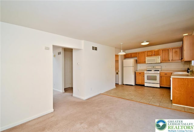5631 Stonecroft Ln, Lower Macungie Twp, PA 18106 - kitchen featuring white appliances, light countertops, light colored carpet, brown cabinets, and hanging light fixtures