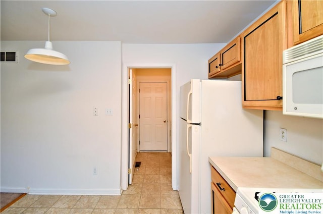 5631 Stonecroft Ln, Lower Macungie Twp, PA 18106 - kitchen with white appliances, light countertops, brown cabinets, hanging light fixtures, and light tile patterned floors