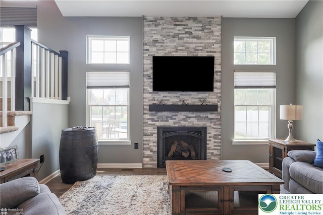 3536 New Hampshire Ave, Bethlehem Twp, PA 18045 - living area with wood finished floors, a tiled fireplace, and stairs