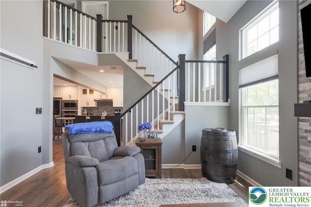 3536 New Hampshire Ave, Bethlehem Twp, PA 18045 - sitting room featuring a towering ceiling, stairs, and wood finished floors