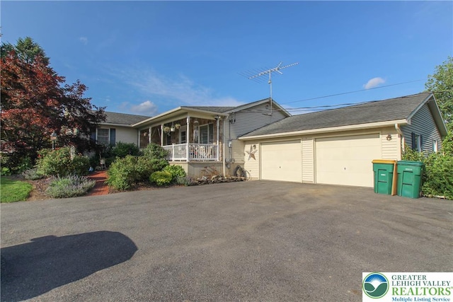 518 Bauer Rd, Moore Twp, PA 18014 - ranch-style home with a garage, covered porch, and asphalt driveway