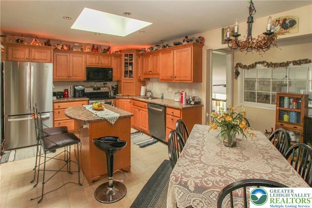 518 Bauer Rd, Moore Twp, PA 18014 - kitchen with stainless steel appliances, a kitchen island, decorative backsplash, a skylight, and recessed lighting
