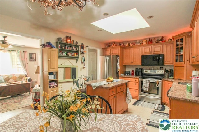 518 Bauer Rd, Moore Twp, PA 18014 - kitchen featuring stainless steel appliances, light stone counters, a skylight, a center island, and glass insert cabinets