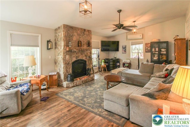 518 Bauer Rd, Moore Twp, PA 18014 - living area featuring wood finished floors, a ceiling fan, vaulted ceiling, a wall mounted AC, and a fireplace