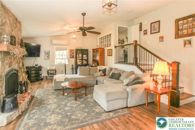 518 Bauer Rd, Moore Twp, PA 18014 - living room featuring an AC wall unit, wood finished floors, ceiling fan, and stairway