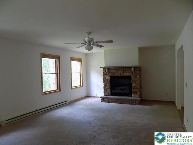 217 St Andrews Dr, Middle Smithfield Twp, PA 18324 - unfurnished living room with a baseboard heating unit, ceiling fan, carpet flooring, and a fireplace