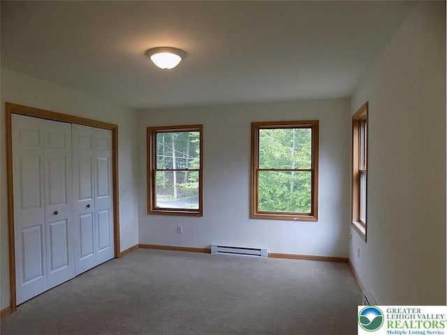 217 St Andrews Dr, Middle Smithfield Twp, PA 18324 - unfurnished bedroom featuring a baseboard radiator, carpet, multiple windows, and a closet