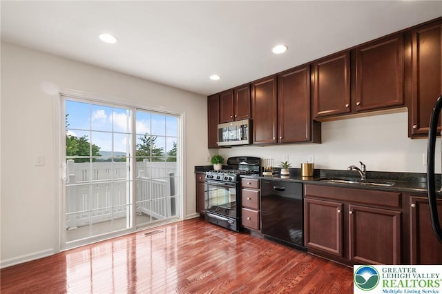 4094 Bunker Hill Dr S, Upper Saucon Twp, PA 18036 - kitchen with black appliances, dark wood-type flooring, recessed lighting, and dark brown cabinets