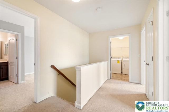 4094 Bunker Hill Dr S, Upper Saucon Twp, PA 18036 - hallway featuring an upstairs landing, washing machine and clothes dryer, and light carpet