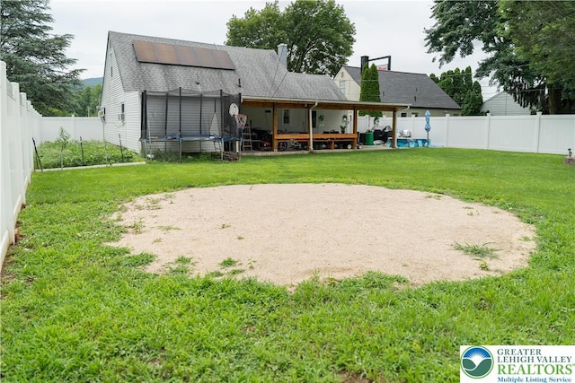 2912 Lehigh St, Allentown City, PA 18103 - rear view of house with roof with shingles, a fenced backyard, a patio, and roof mounted solar panels