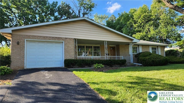 2425 Pennsylvania St, South Whitehall Twp, PA 18104 - ranch-style home with covered porch, brick siding, driveway, and a front yard