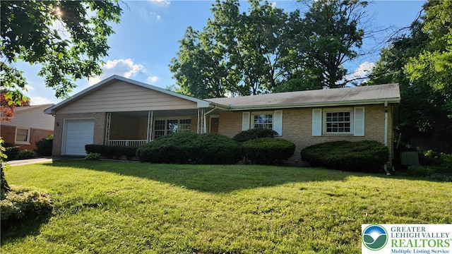 2425 Pennsylvania St, South Whitehall Twp, PA 18104 - ranch-style house featuring a garage, brick siding, and a front yard