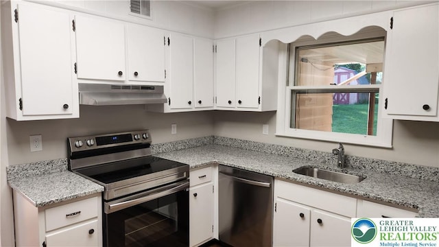2425 Pennsylvania St, South Whitehall Twp, PA 18104 - kitchen with appliances with stainless steel finishes, under cabinet range hood, white cabinets, and light stone countertops