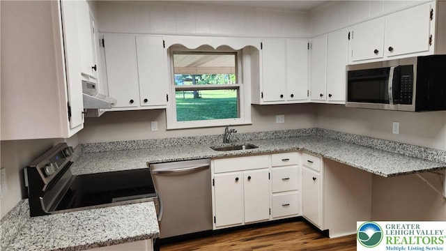 2425 Pennsylvania St, South Whitehall Twp, PA 18104 - kitchen featuring stainless steel appliances, white cabinetry, dark wood-style flooring, and under cabinet range hood