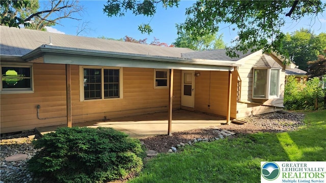 2425 Pennsylvania St, South Whitehall Twp, PA 18104 - back of house with roof with shingles, a patio area, and a yard