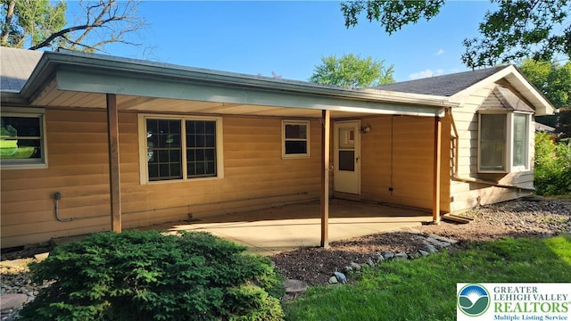 2425 Pennsylvania St, South Whitehall Twp, PA 18104 - rear view of house with a shingled roof and a patio area