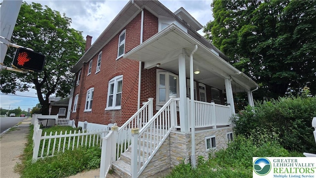 1500 Schuylkill Ave, Reading City, PA 19601 - view of front of house featuring brick siding, covered porch, and a chimney