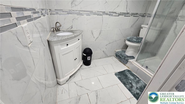 1500 Schuylkill Ave, Reading City, PA 19601 - bathroom with marble look tiles, vanity, a shower stall, and tile walls