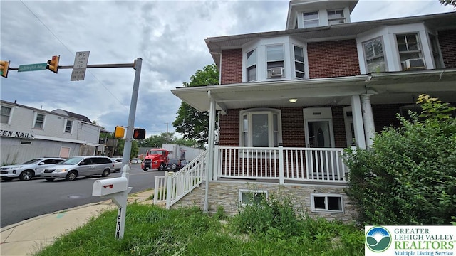 1500 Schuylkill Ave, Reading City, PA 19601 - view of side of home featuring brick siding, covered porch, and cooling unit
