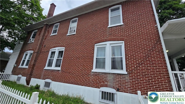 1500 Schuylkill Ave, Reading City, PA 19601 - view of side of home with brick siding, a chimney, and cooling unit
