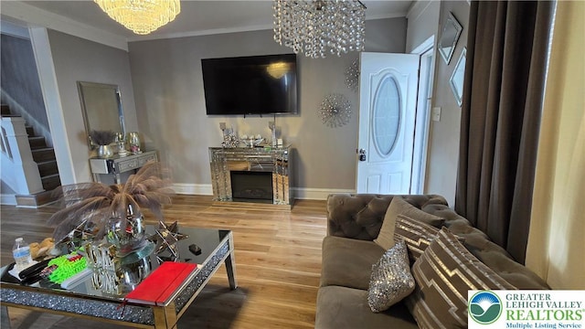 1500 Schuylkill Ave, Reading City, PA 19601 - living area with a chandelier, a fireplace, wood finished floors, crown molding, and stairs