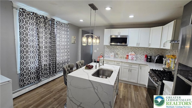 1500 Schuylkill Ave, Reading City, PA 19601 - kitchen with appliances with stainless steel finishes, baseboard heating, light stone counters, white cabinetry, and recessed lighting