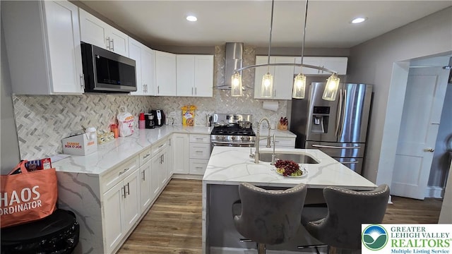 1500 Schuylkill Ave, Reading City, PA 19601 - kitchen with stainless steel appliances, wall chimney range hood, white cabinetry, and recessed lighting