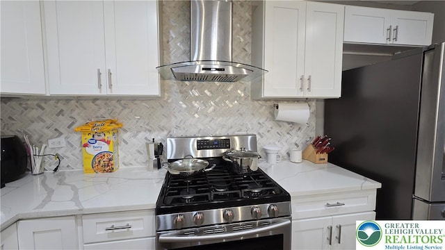 1500 Schuylkill Ave, Reading City, PA 19601 - kitchen with appliances with stainless steel finishes, wall chimney exhaust hood, white cabinets, and decorative backsplash