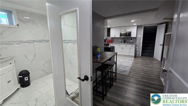 1500 Schuylkill Ave, Reading City, PA 19601 - kitchen featuring stainless steel microwave, white cabinetry, recessed lighting, dark marble finish flooring, and tasteful backsplash