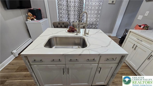1500 Schuylkill Ave, Reading City, PA 19601 - kitchen with a baseboard heating unit, dark wood-style floors, and light stone counters