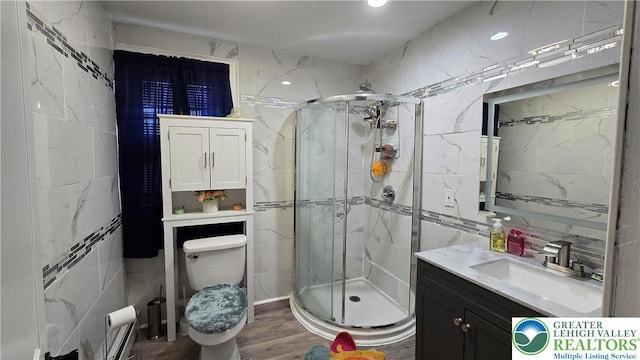 1500 Schuylkill Ave, Reading City, PA 19601 - full bathroom featuring vanity, tile walls, a shower stall, and wood finished floors