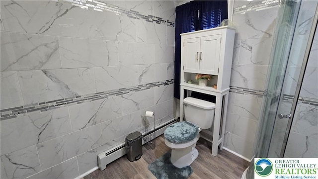 1500 Schuylkill Ave, Reading City, PA 19601 - bathroom featuring a baseboard heating unit, wood finished floors, and a stall shower
