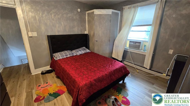1500 Schuylkill Ave, Reading City, PA 19601 - bedroom featuring a baseboard radiator, wood finished floors, and cooling unit