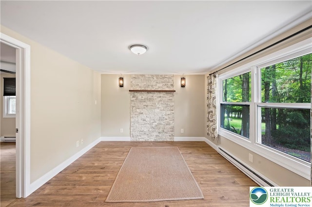 29 Long Brook Way, Penn Forest Twp, PA 18210 - unfurnished room featuring baseboard heating, healthy amount of natural light, and wood finished floors