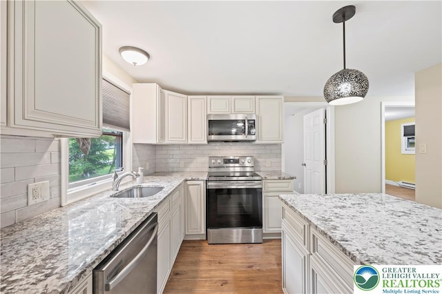 29 Long Brook Way, Penn Forest Twp, PA 18210 - kitchen featuring appliances with stainless steel finishes, decorative backsplash, decorative light fixtures, and light stone countertops