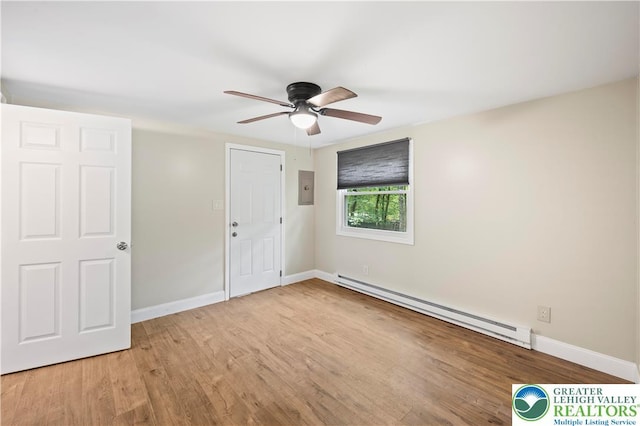 29 Long Brook Way, Penn Forest Twp, PA 18210 - unfurnished bedroom with a baseboard heating unit, electric panel, wood finished floors, and a ceiling fan