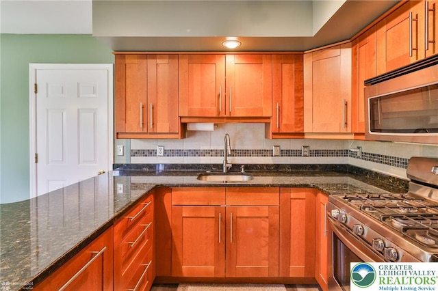 1945 Jenkins Dr, Forks Twp, PA 18040 - kitchen featuring stainless steel appliances, dark stone counters, and brown cabinetry