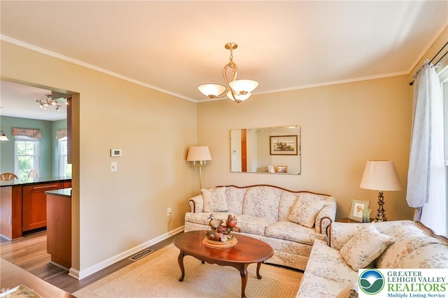 1945 Jenkins Dr, Forks Twp, PA 18040 - living area with a chandelier, crown molding, and light wood finished floors