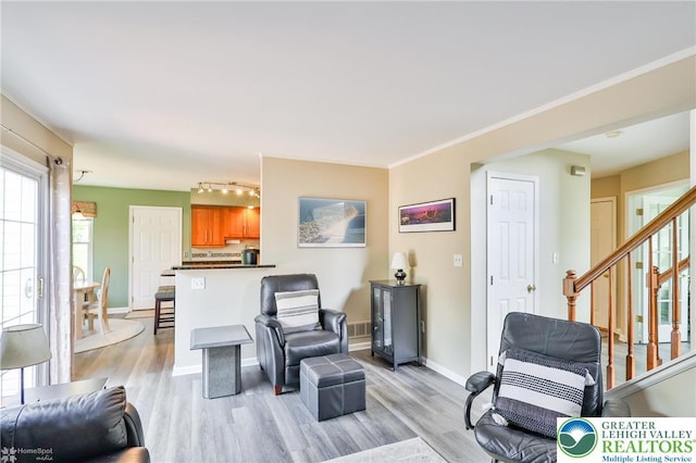 1945 Jenkins Dr, Forks Twp, PA 18040 - living room featuring light wood-style flooring, rail lighting, and stairway