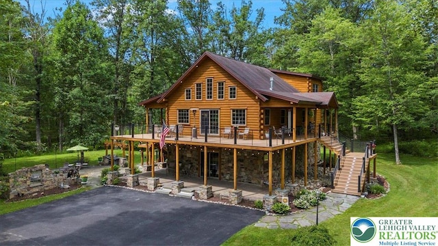 207 W Douglasville Rd, Bushkill Twp, PA 18064 - rear view of house with stairway, a patio, a wooden deck, a yard, and log siding