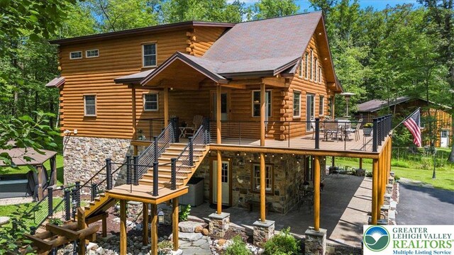 207 W Douglasville Rd, Bushkill Twp, PA 18064 - view of front of property with stairs, log exterior, stone siding, a deck, and driveway