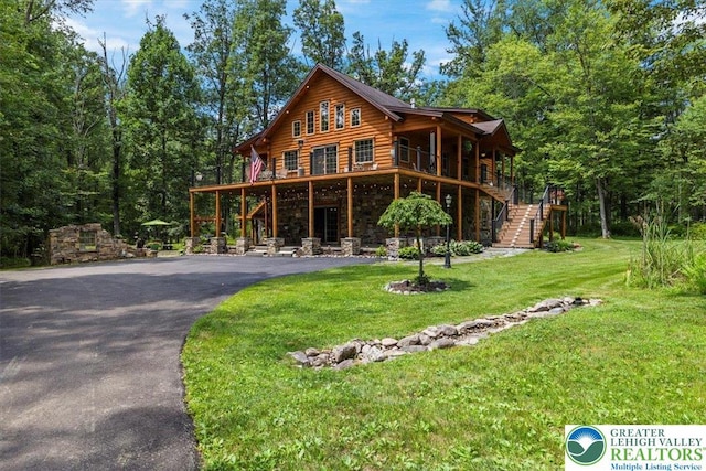 207 W Douglasville Rd, Bushkill Twp, PA 18064 - view of front facade with stairway, a front lawn, stone siding, and asphalt driveway