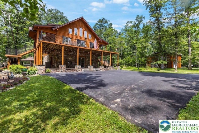207 W Douglasville Rd, Bushkill Twp, PA 18064 - back of house with a yard, stone siding, and asphalt driveway