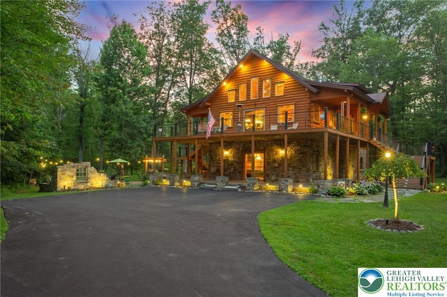 207 W Douglasville Rd, Bushkill Twp, PA 18064 - log cabin with a front lawn, asphalt driveway, stone siding, and log exterior
