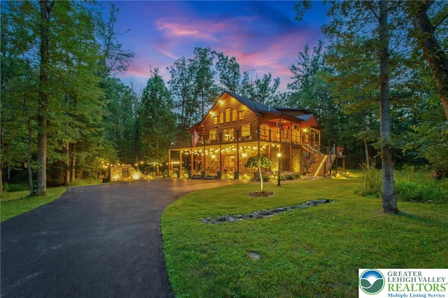 207 W Douglasville Rd, Bushkill Twp, PA 18064 - chalet / cabin featuring asphalt driveway, stairway, a lawn, and a wooden deck